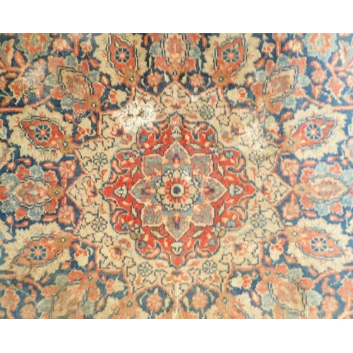 1285 - An antique Persian rug with floral medallion on a blue ground, 195 x 137cm