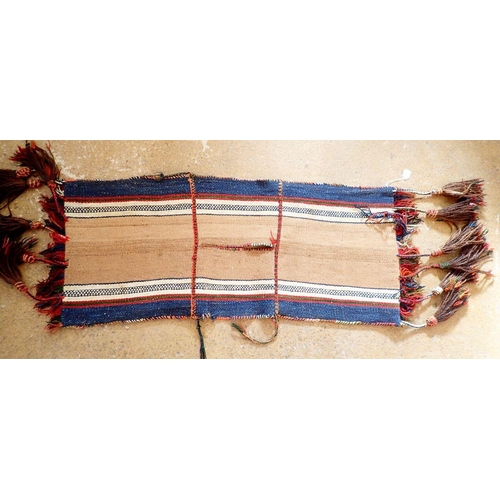 1288 - An antique camel saddle bag from Jordan, with geometric decoration and long tassels, 110 x 48cm plus... 