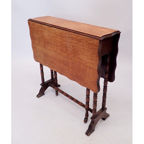 1291 - An Edwardian oak Sutherland table with wavy edge on turned supports, 62cm high x 61cm wide