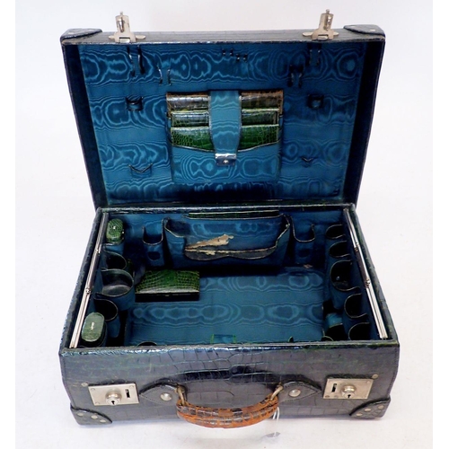 1301 - A dark green leather gentleman's travelling suitcase fitted with correspondence folders, inkwell, pe... 