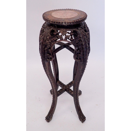 1316 - A Chinese hardwood carved jardiniere stand with marble top, 67cm high