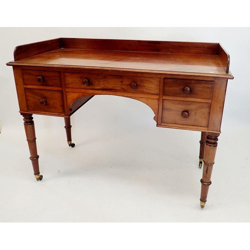 1319 - An early 19th century mahogany dressing table with five drawers raised on slender turned supports, 1... 