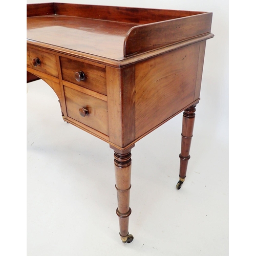 1319 - An early 19th century mahogany dressing table with five drawers raised on slender turned supports, 1... 