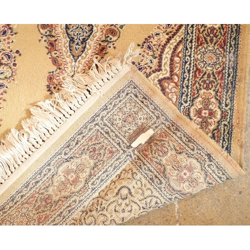 1334 - A small Persian style rug on a yellow ground, 175cm long x 90cm wide