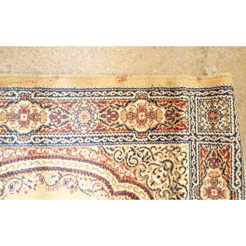 1334 - A small Persian style rug on a yellow ground, 175cm long x 90cm wide