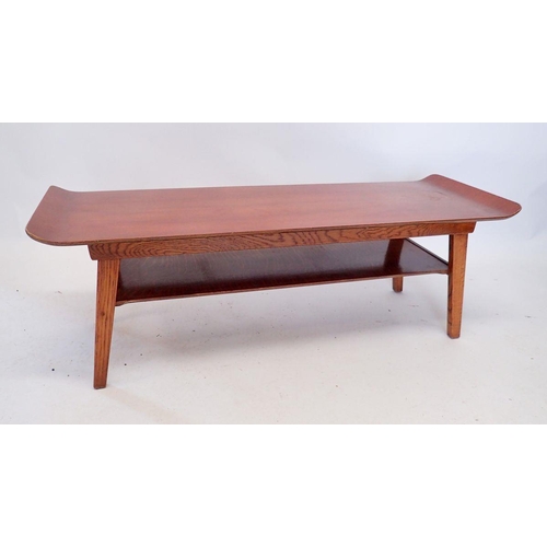 1336 - A retro oak finish long coffee table with magazine shelf under and makers mark to underside, 112cm w... 