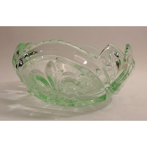 162 - A moulded green glass bowl with fleur de lys decoration, 23cm diameter