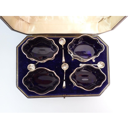 220 - A set of four silver salts with blue glass liners and spoons - cased, George Unite, Chester 1901, 24... 