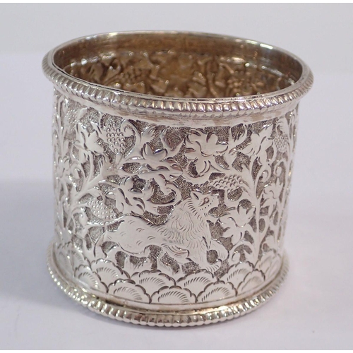 222 - An Indian white metal napkin ring embossed animals, 34g