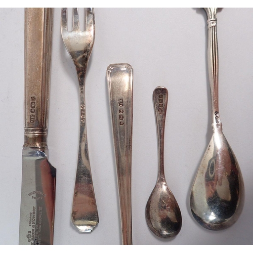 241 - A set of six 900 standard silver cake forks, three various spoons and a silver handled knife