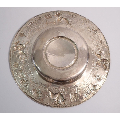 249 - A 17th century silver dish with engraved armorial to the centre and embossed scenes to the wide rim ... 