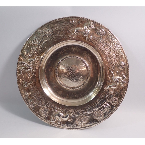 249 - A 17th century silver dish with engraved armorial to the centre and embossed scenes to the wide rim ... 