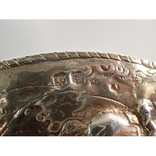 249 - A 17th century silver dish with engraved armorial to the centre and embossed scenes to the wide rim ... 