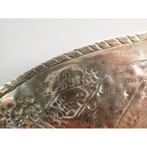 249 - A 17th century silver dish with engraved armorial to the centre and embossed scenes to the wide rim ... 