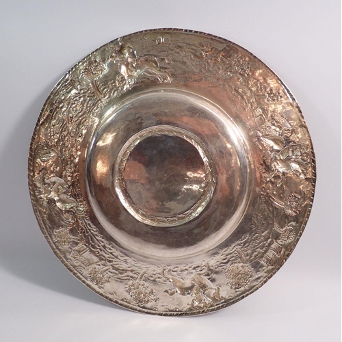 249 - A 17th century silver dish with engraved armorial to the centre and embossed scenes to the wide rim ... 