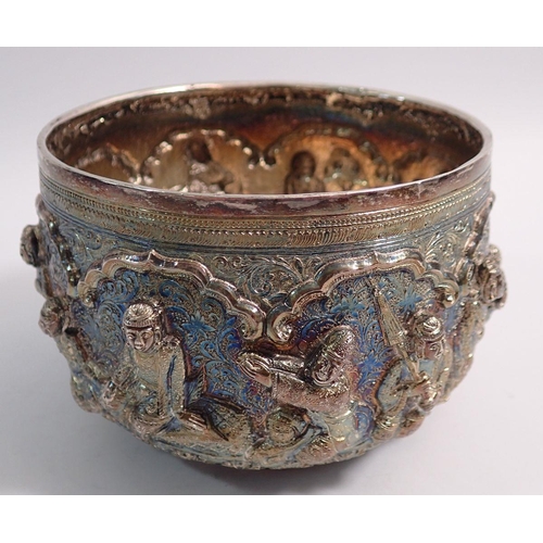 253 - A Burmese silver Thabeik rice bowl chased with a king and attendant figures in high relief, 336g, 12... 