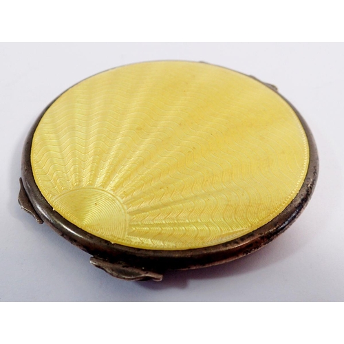 293 - A yellow enamel and silver Art Deco sunray compact, Birmingham 1937, 6cm diameter