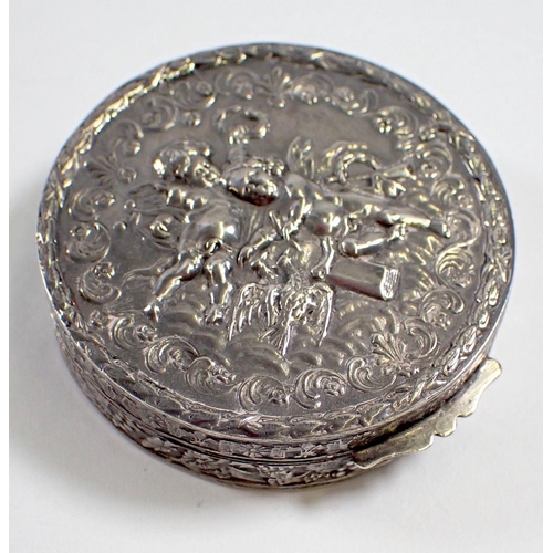 299 - A silver circular trinket box embossed cherubs, 5.5cm diameter, import mark 1979