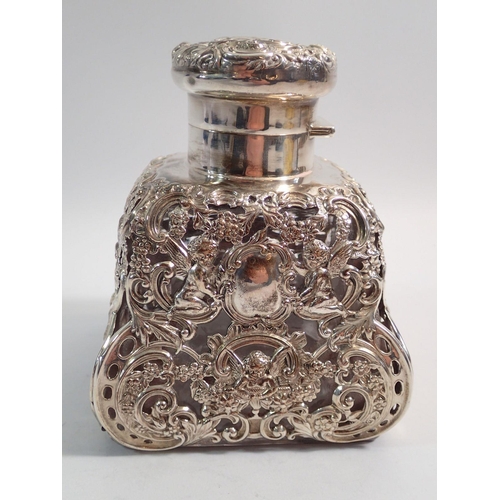 323 - A large silver clad glass scent bottle or ink well with cherub and floral decoration, 13cm tall, Lon... 