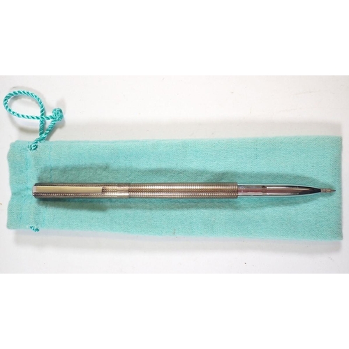 344A - A Tiffany silver gilt pen and a Tiffany Paloma Picasso red and sterling silver swivel pen, both with... 