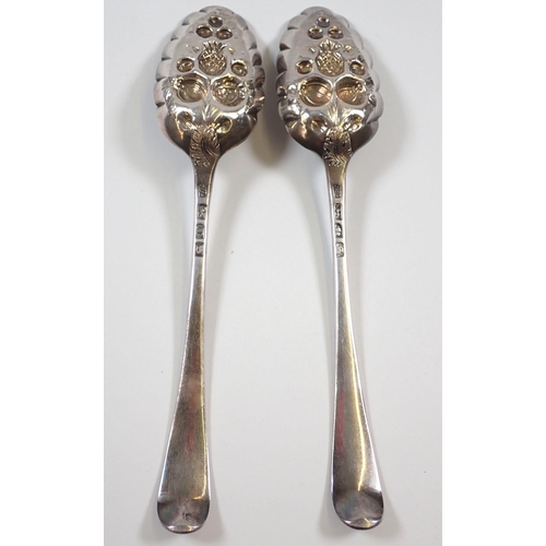 351 - A pair of Georgian silver berry spoons with later embossed decoration, London 1773 by John Lampfert,... 