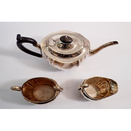 373 - A silver three piece tea service with fluted decoration, Birmingham 1931, 1110g