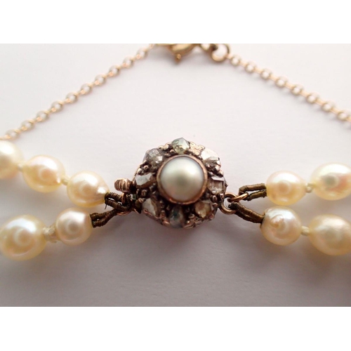 382 - An antique double row graduated pearl necklace with gold clasp set old cut diamonds with safety chai... 