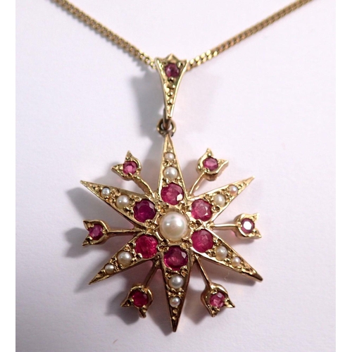 384 - A 9 carat gold star form pendant set rubies and seed pearls on 9 carat gold chain, pendant 2.5cm dia... 