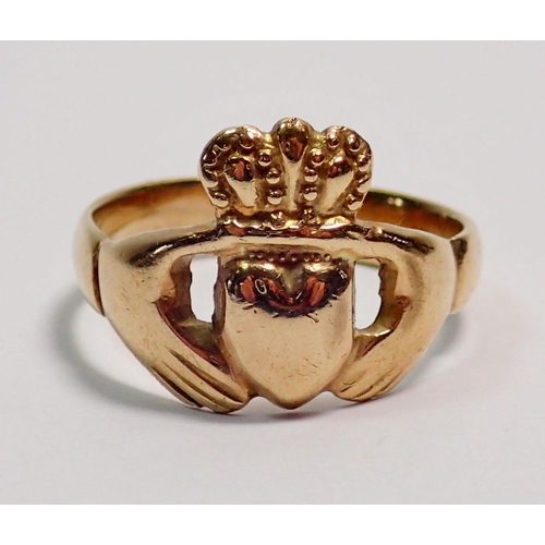 399 - A gold Claddagh ring with two hands holding crowned heart, size Q-R, unmarked, 4.7g