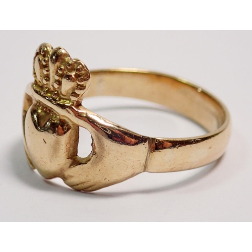 399 - A gold Claddagh ring with two hands holding crowned heart, size Q-R, unmarked, 4.7g