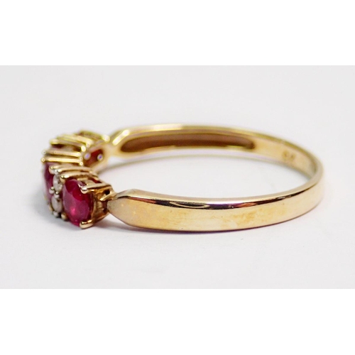 415 - A 9 carat gold ring set row of four rubies and six diamonds, size P, 1.8g