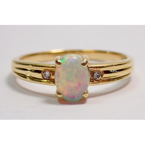 424 - An 18 carat gold opal ring inset two diamonds to redded barrel, size N to O, 2.5g