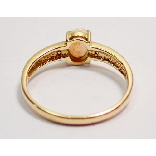 424 - An 18 carat gold opal ring inset two diamonds to redded barrel, size N to O, 2.5g