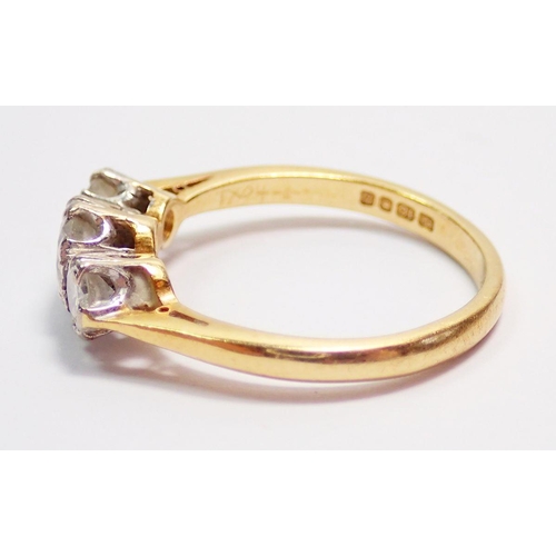 435 - An 18 carat gold three stone diamond ring, size J, 2.5g