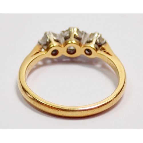 435 - An 18 carat gold three stone diamond ring, size J, 2.5g