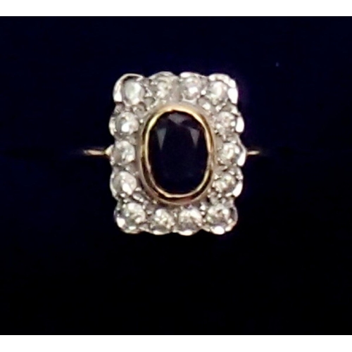 438 - An antique 9 carat gold ring, the oval cut sapphire within rectangular plaque set fourteen diamonds,... 