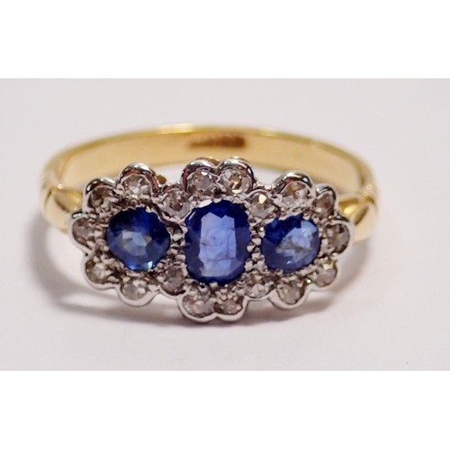 441 - An 18 carat gold ring set three sapphires within diamond surround, size K to L, 2.5g