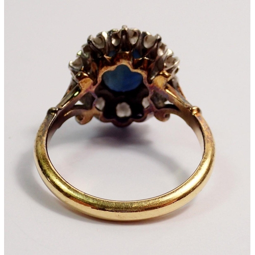 443 - An 18 carat gold sapphire and diamond cluster ring, sapphire 8 x 6mm, size N, 5.2g - boxed