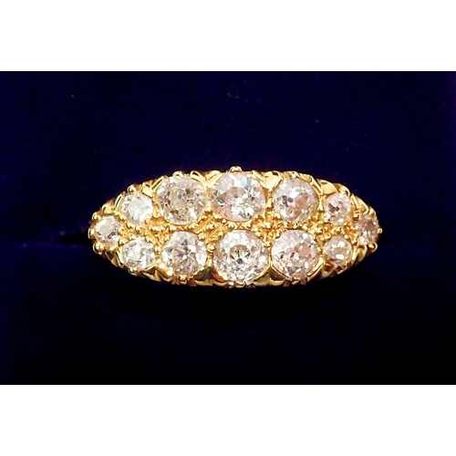 444 - An 18 carat gold ring set double row of twelve graduated diamonds, largest stones 4mm, size N, 5.3g