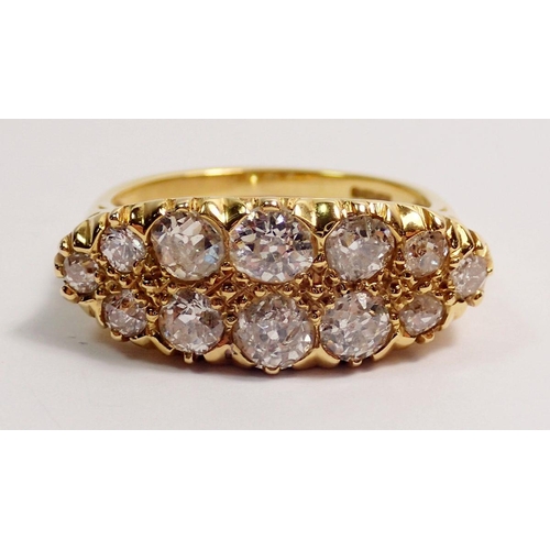 444 - An 18 carat gold ring set double row of twelve graduated diamonds, largest stones 4mm, size N, 5.3g