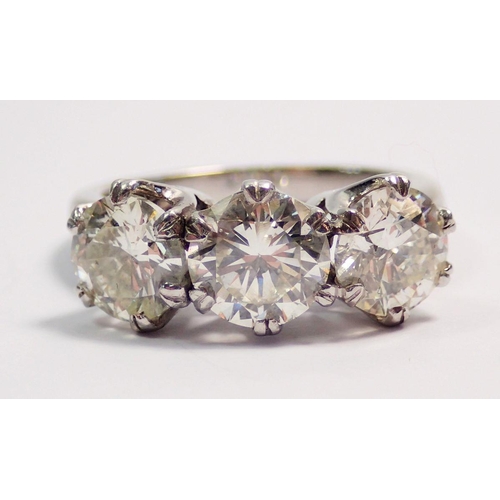 448 - A fine platinum three stone diamond ring, approx 3cts in total, size L to M, 7.4g