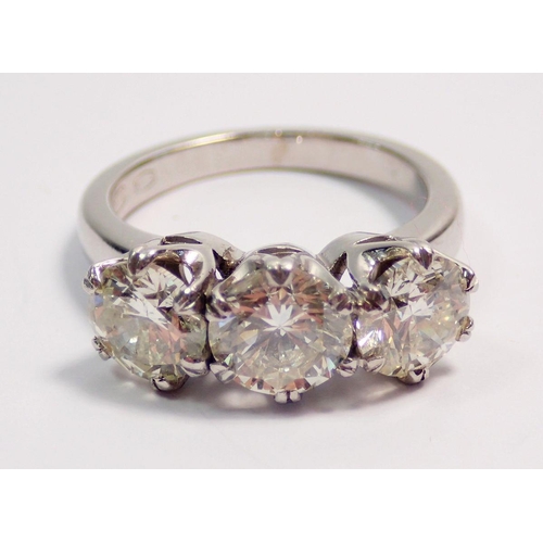 448 - A fine platinum three stone diamond ring, approx 3cts in total, size L to M, 7.4g