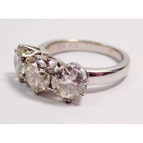 448 - A fine platinum three stone diamond ring, approx 3cts in total, size L to M, 7.4g