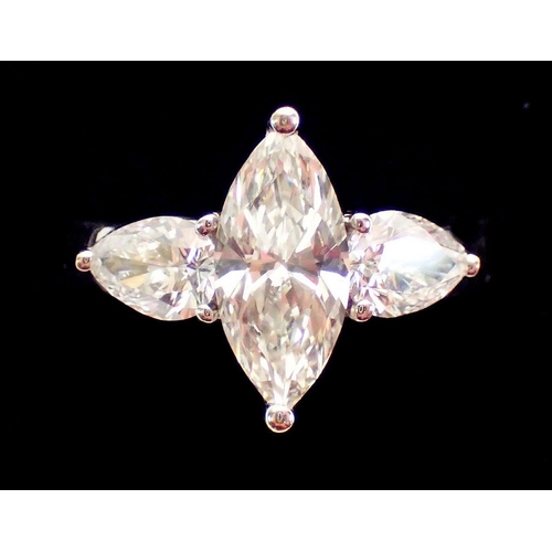 450 - An 18 carat white gold ring set marquise cut diamond flanked by two pear cut diamonds, size L, 5.8g ... 