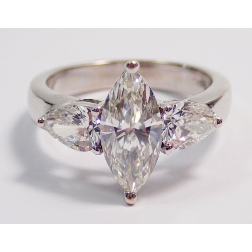 450 - An 18 carat white gold ring set marquise cut diamond flanked by two pear cut diamonds, size L, 5.8g ... 