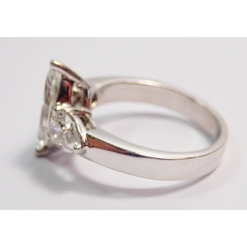 450 - An 18 carat white gold ring set marquise cut diamond flanked by two pear cut diamonds, size L, 5.8g ... 