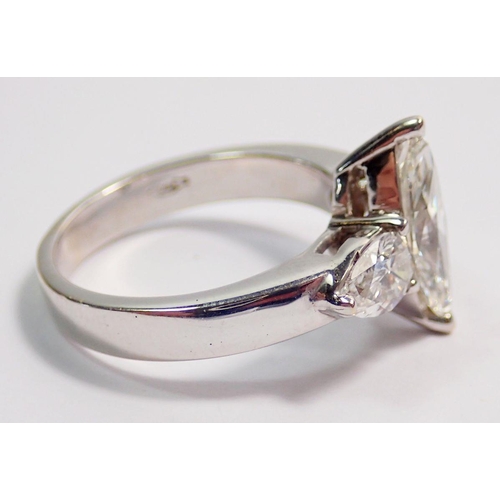 450 - An 18 carat white gold ring set marquise cut diamond flanked by two pear cut diamonds, size L, 5.8g ... 