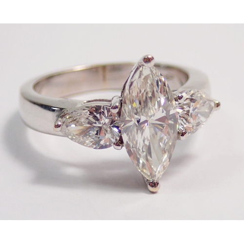 450 - An 18 carat white gold ring set marquise cut diamond flanked by two pear cut diamonds, size L, 5.8g ... 