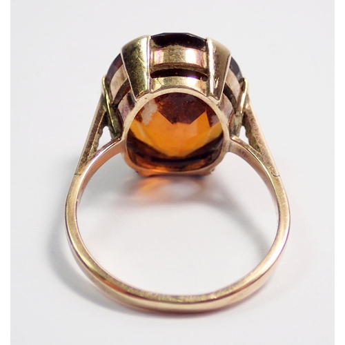 452 - A 9 carat gold ring set orange stone, unmarked, size O, 4.9g