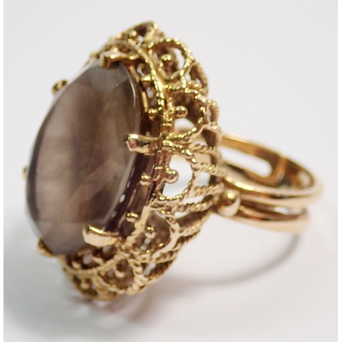 454 - A 9 carat gold smoky quartz dress ring in fancy pierced setting, stone 2 x 1.6cm, size K, total weig... 